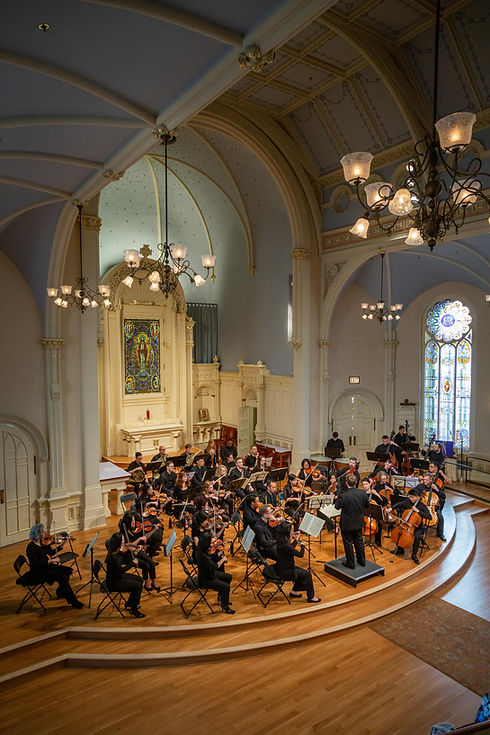 Orchestra performing live concert inside historic church venue during event in San Francisco