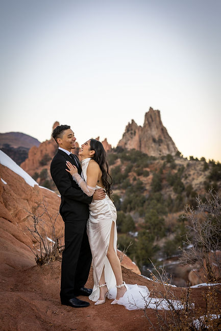 Winter elopement at High Point in Garden of the Gods with a couple laughing in front of snowy red rock formations