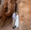 Engaged couple embracing between red rock formations at Garden of the Gods in Colorado Springs