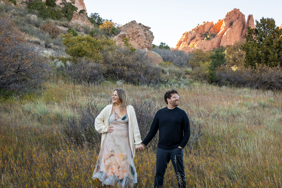 Couple sharing a kiss during sunset at Garden of the Gods engagement session
