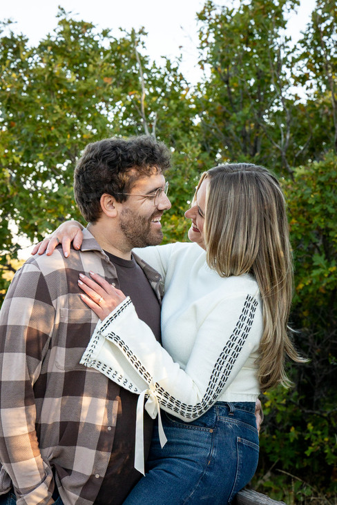 Romantic photo of couple standing on rocky overlook at Garden of the Gods
