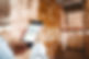 hand holding smartphone against shelves