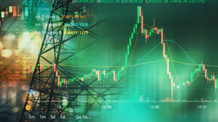 Stock market graph overlaid on a city skyline with bright lights. Green and red candlesticks with technical indicators and numbers visible.