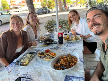 Remote workers sharing lunch and coffee together at coliving Italy community moment