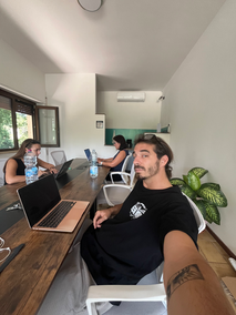 Remote workers collaborating on projects at coliving Italy coworking space with reliable internet