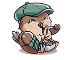 Nesto with a green hat eating pasta.