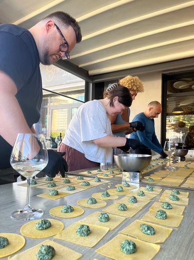 Nesting Away coliving guests making fresh ravioli during a cooking class in Orte, Lazio, Italy