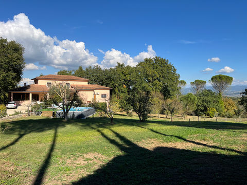 Distant villa view from the garden at a coliving in Italy near Rome.