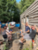 Paddle Cabin members outside the cabin in the sunshine first pumping the iar