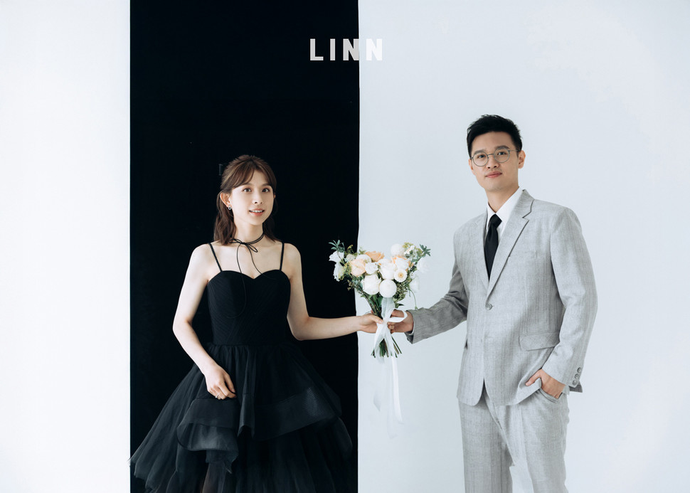 Classic wedding couple portrait in gray suit and white bridal gown.