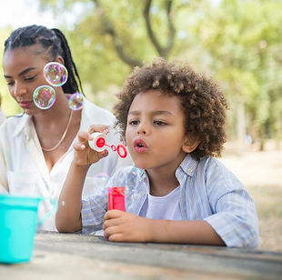 boy blowing bubbles