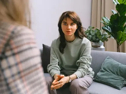 A woman sitting in talk therapy.