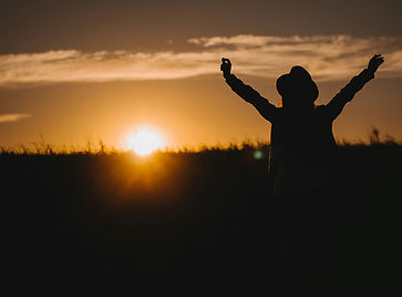 A person with their arms raised in excitment