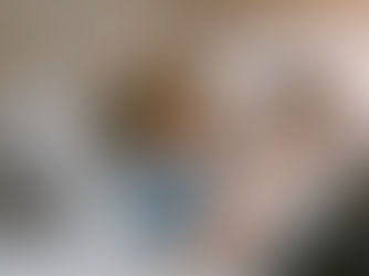 A child laying on the couch watching his smart phone