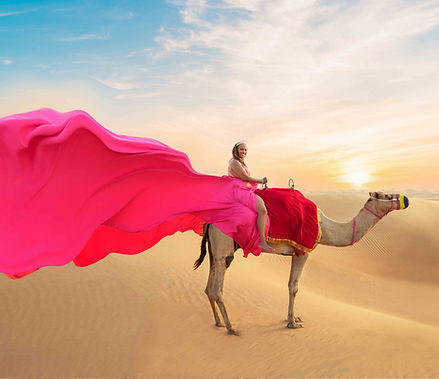 Solo model posing in a vibrant satin gown during a flying dress dubai desert photoshoot. Solo model posing in a vibrant satin gown during a flying dress dubai desert photoshoot.