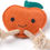 Thumbnail: Smiling orange apple dog toy with rope, Eco Dog Toy for playful dogs.
