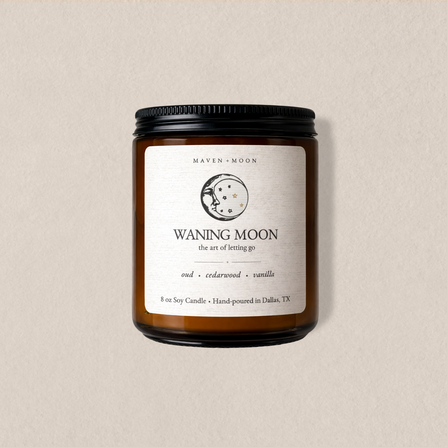 Waning Moon soy candle in amber glass jar with moon phase label on neutral background