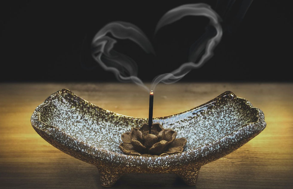 burning love infused incense stick whose smoke makes the shape of a heart