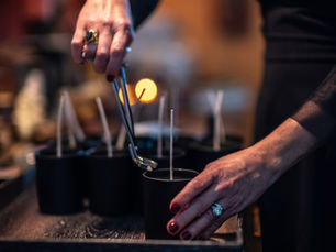 A witchy woman trimming candle wick