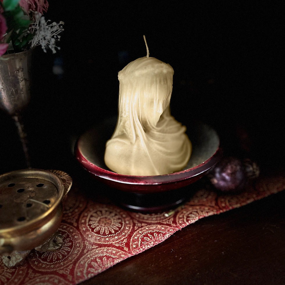 Thumbnail: close up shot of a cream beeswax veiled lady candle sitting in a soap stone offering dish on an altar with pomegranates