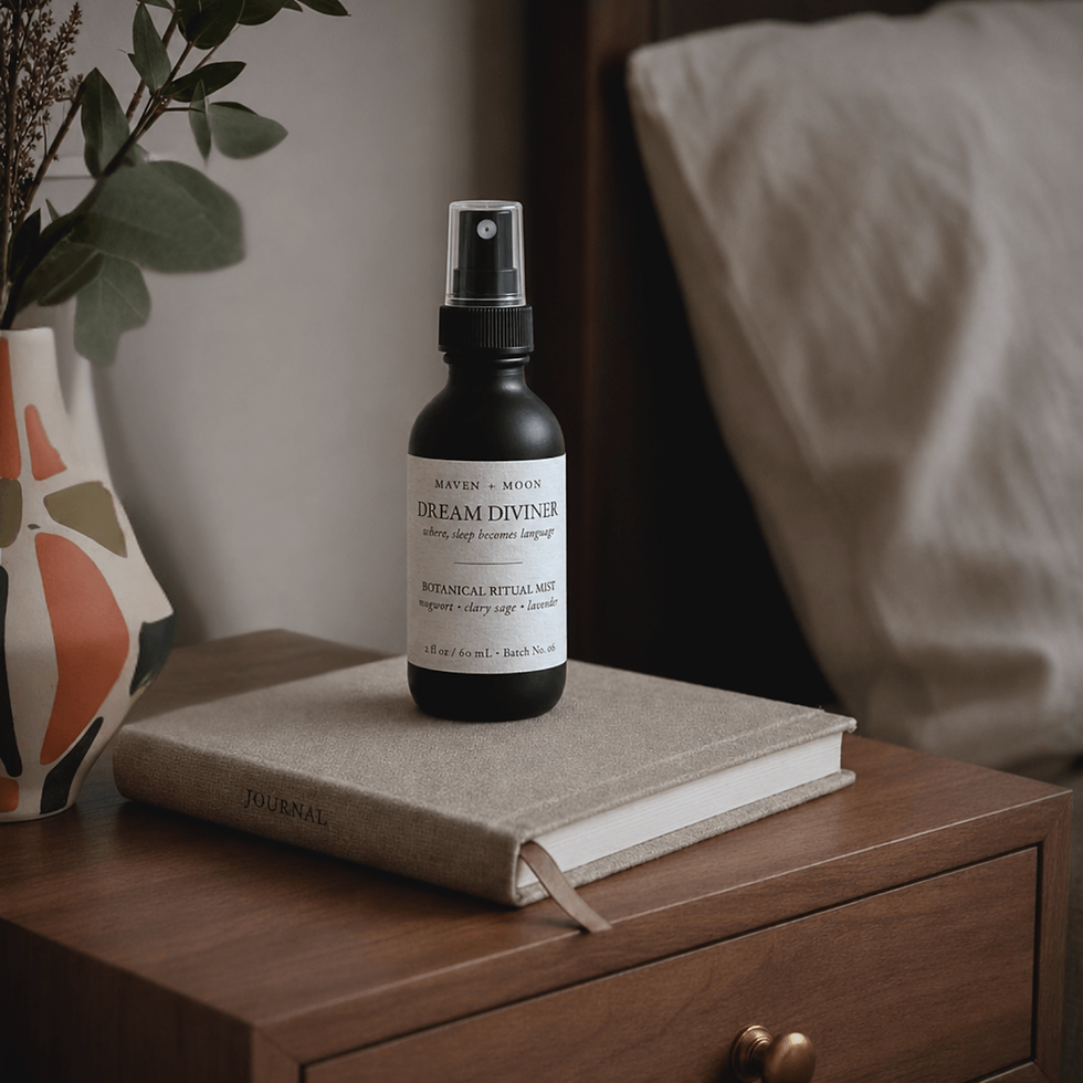 Thumbnail: Dream Diviner botanical mist spray bottle on wooden nightstand stacked on a journal beside a bed, softly lit, warm neutral t
