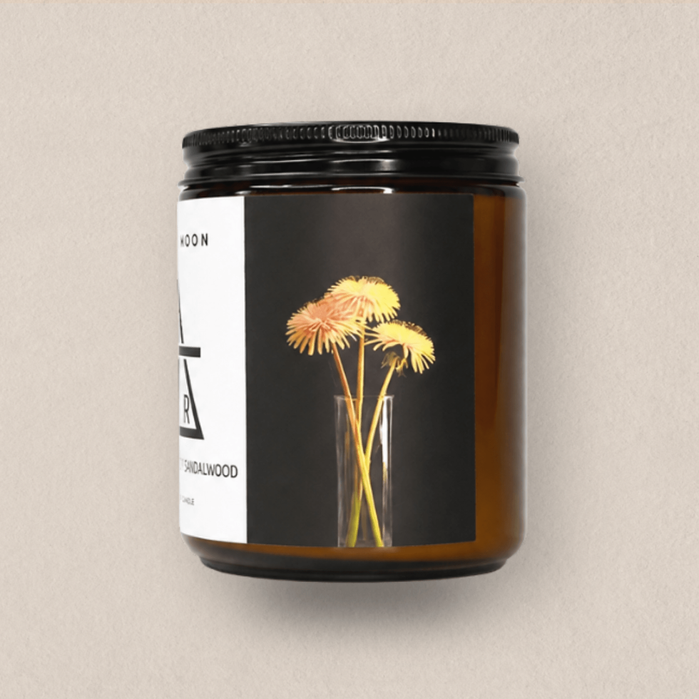 Thumbnail: Air Element soy candle in an amber glass jar with balck screw top lid, photographed against a soft parchment-toned background