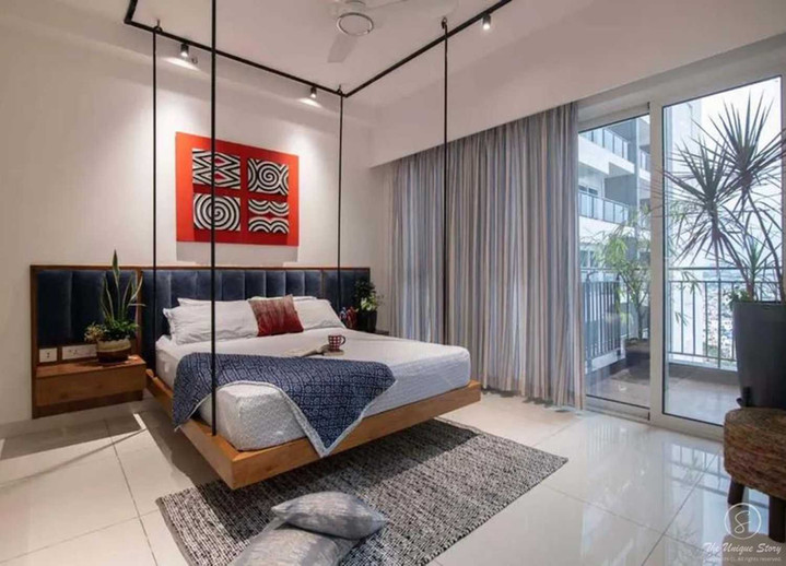 Contemporary Industrial Bedroom interior design with suspended platform bed with a wooden base anchored to black ceiling tracks via thick ropes.