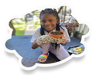 smiling little girl holding a plant
