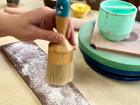 Applying cornstarch to clay as a release agent.