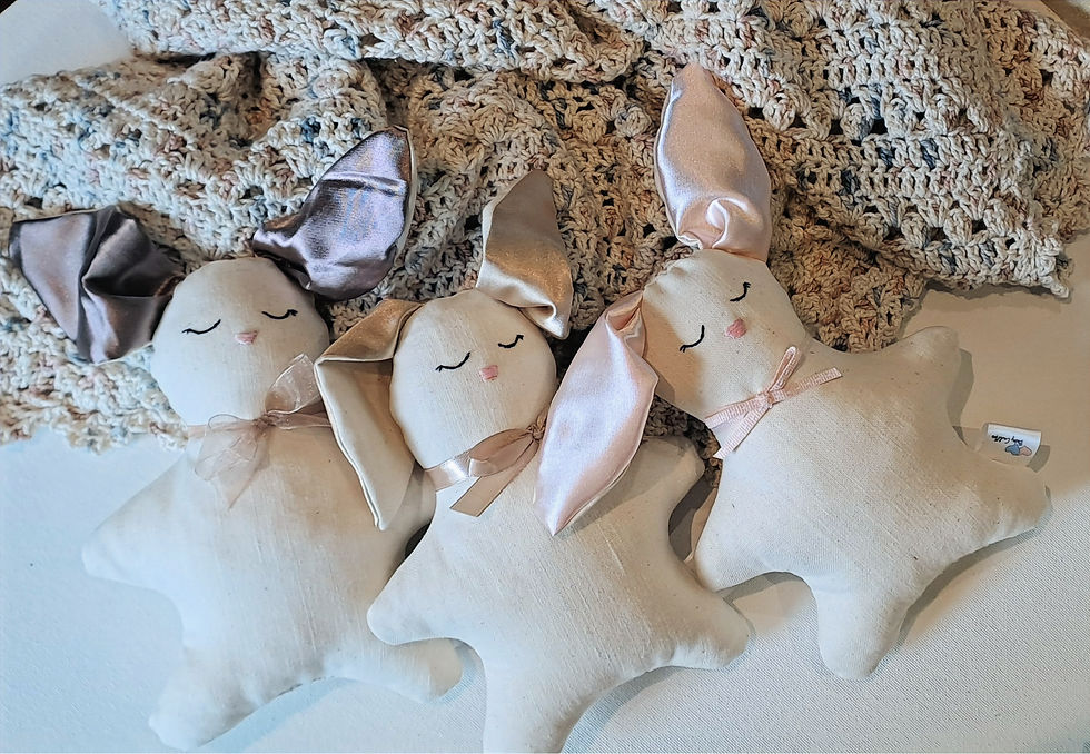 Baby cot bunnies on handmade baby blanket