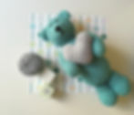 Adorable jade crocheted teddy bear holding heart