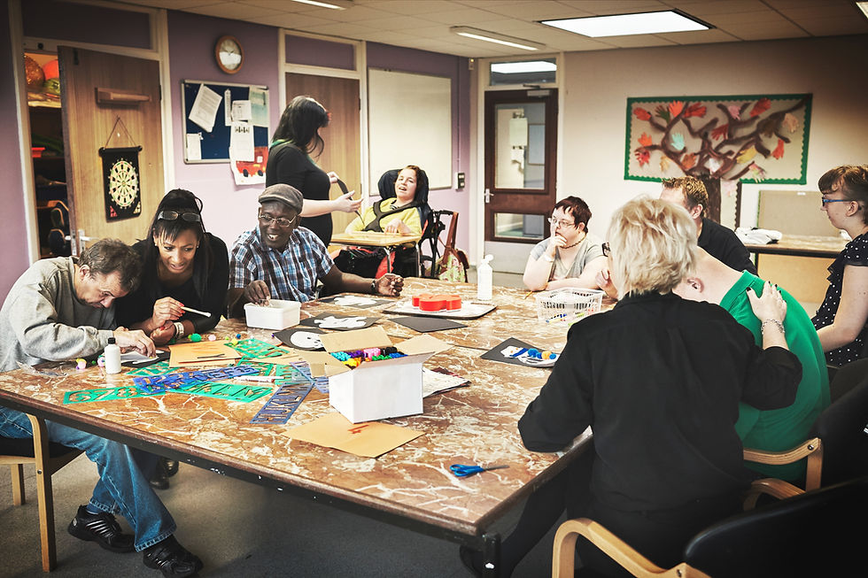 Painting, learning and disability with a volunteer, charity or social worker working with