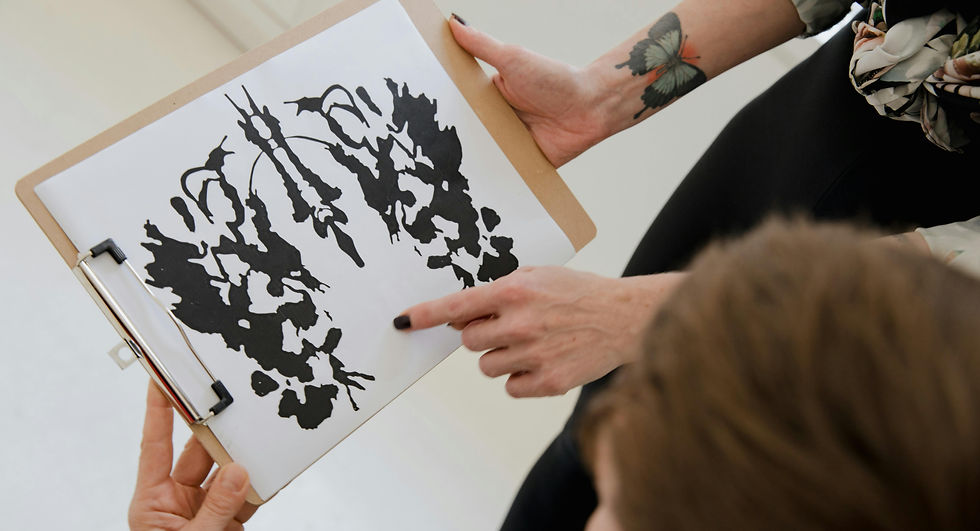 a therapist administering the ink blot test