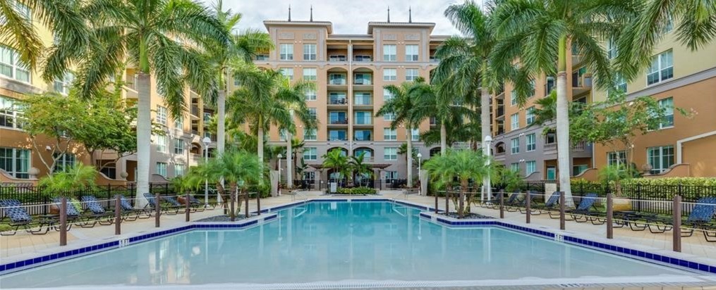Alta Mar courtyard swimming pool with palm trees and surrounding residences