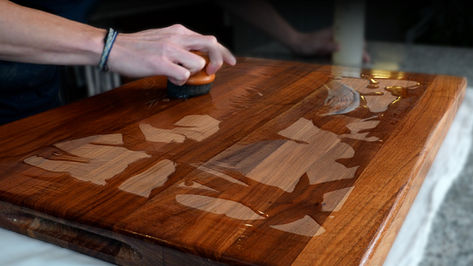 person cleaning a cutting board