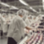 genuine people's back showing who are working in a makeup manufacturing factory