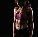 Woman with toned abs in sports bra