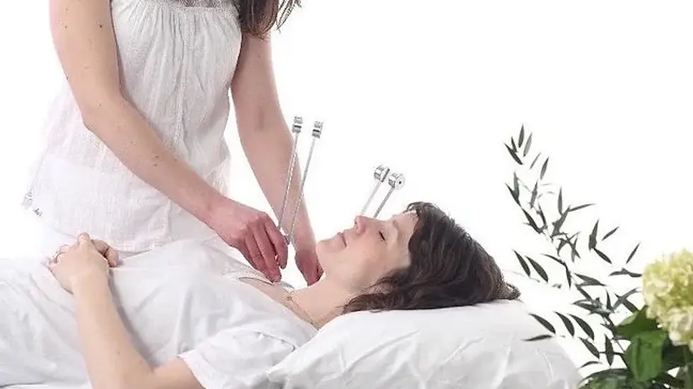 High angle view of a sound therapy session with tuning forks and singing bowls