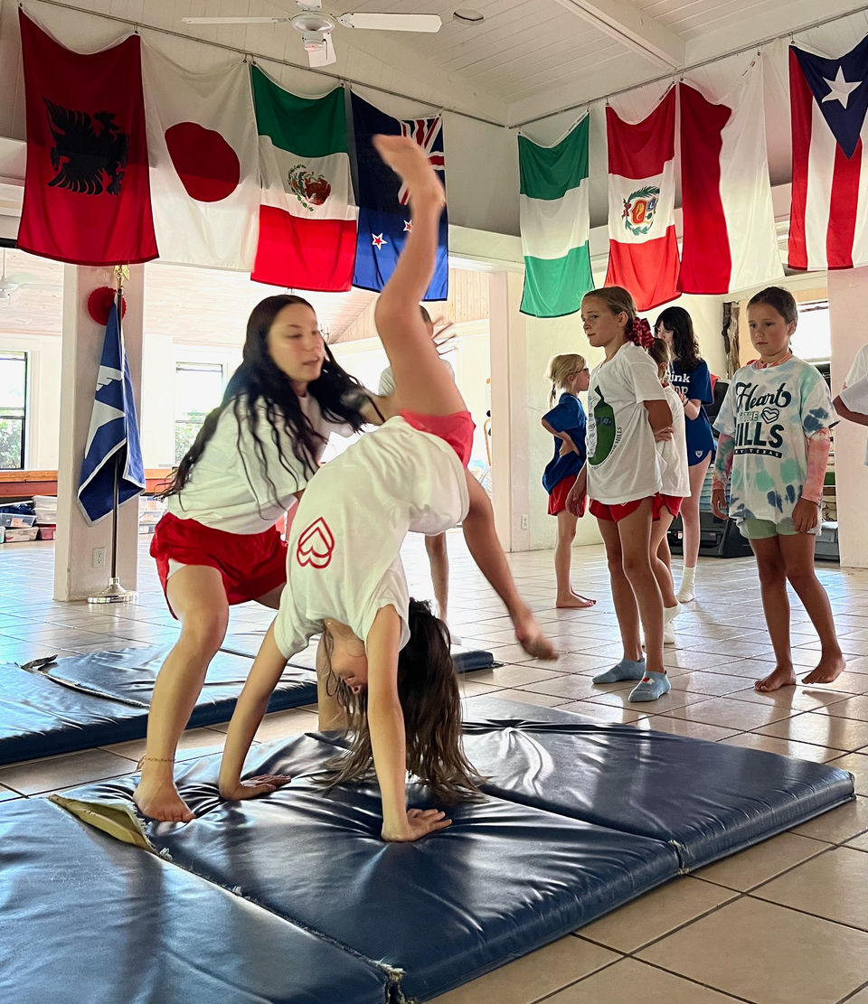 A gymnast with her spotter