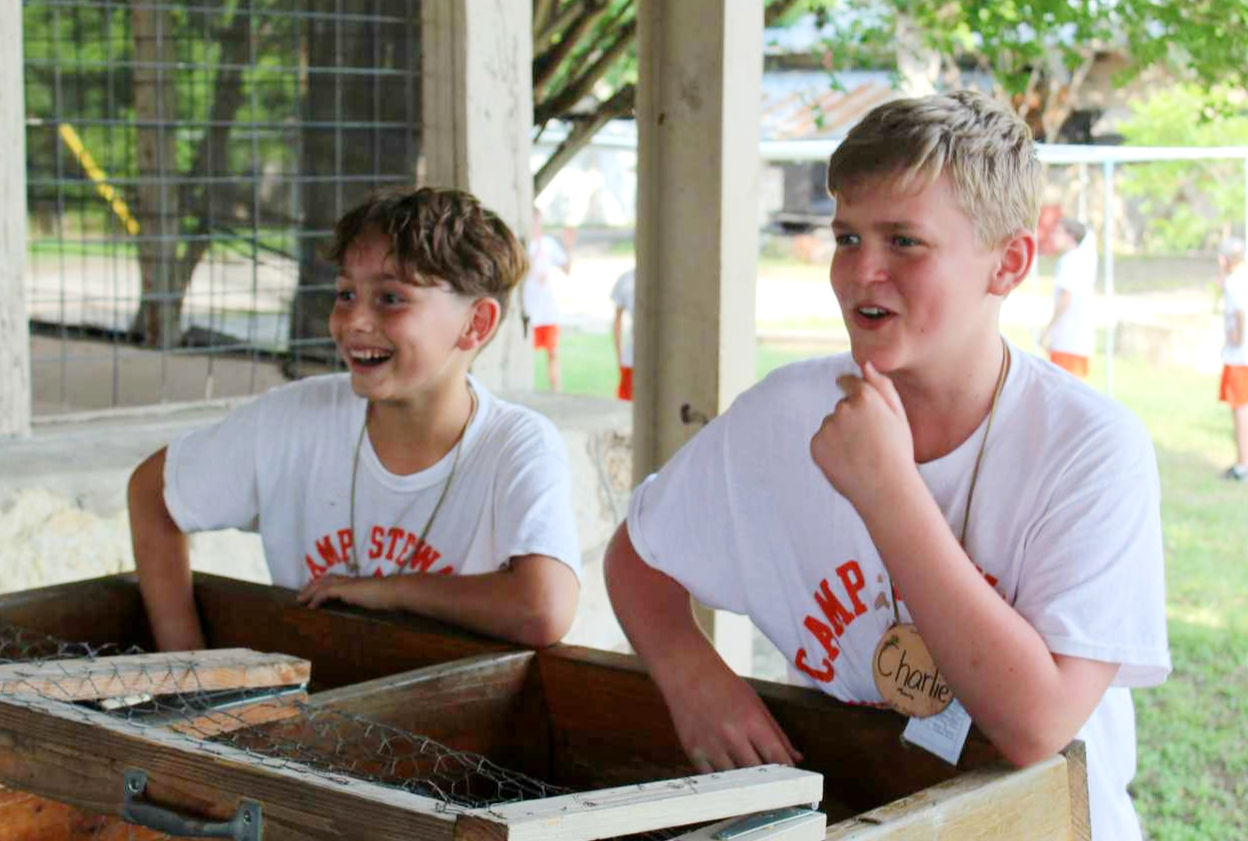 Two boys playing a game outdoors at Camp Stewart