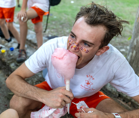 Teenage boy eating cotton candy