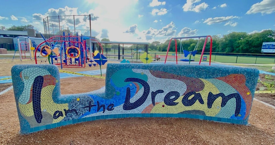 The back of a mosaic tiled bench in Martin Luther King Park in San Antonio, with "I am the Dream" spelled out in mosaic tiles.