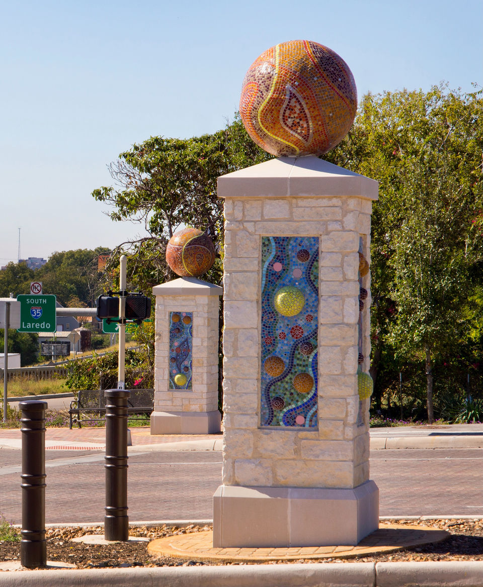 Two mosaic tiled pillars with a globe structure on top at the entrance to Walters Street in San Antonio.