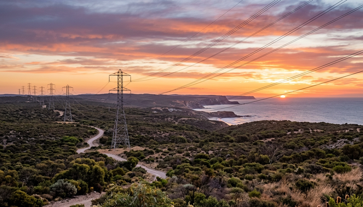 Wide-angle view of a coastal power line at sunset in Australia