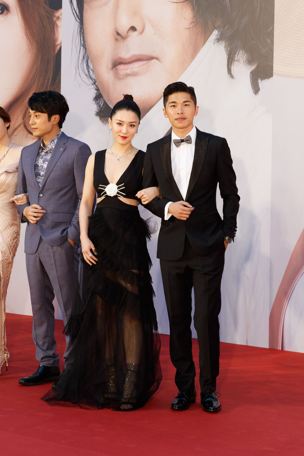 游學修身穿黑色禮服,出席大型頒獎典禮紅毯,與其他演員合影。