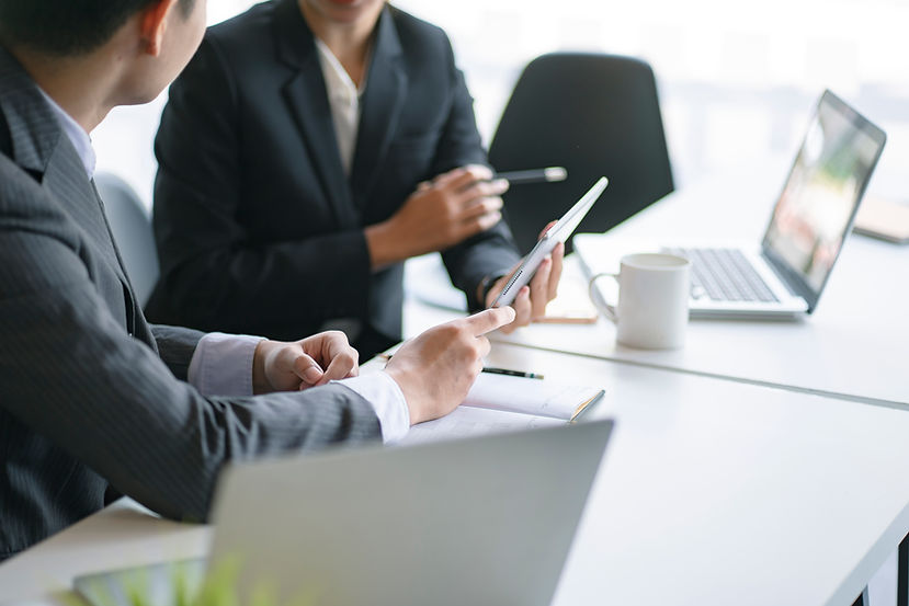 midsection-businessmen-discussing-desk-office.jpg