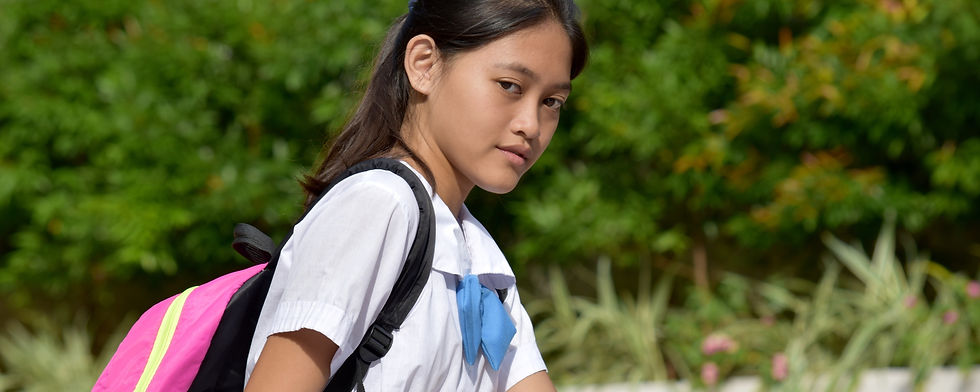 A female student dressed in a school uniform at the Philippines