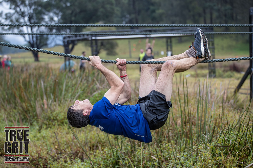 Personal trainer Ash Radford moving along a rope