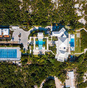 Aerial top view of Triton Villa estate in Turks and Caicos showing residence, pools, beach, and tropical grounds