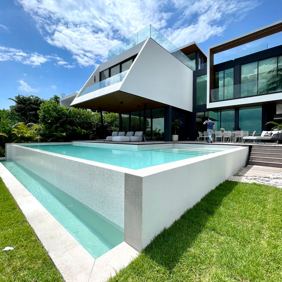 Modern poolside exterior with infinity-edge pool and glass facade in Miami